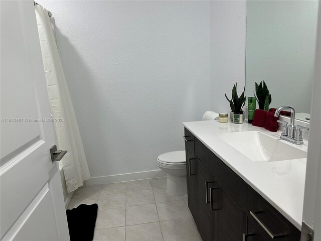 bathroom with vanity, toilet, and tile patterned floors