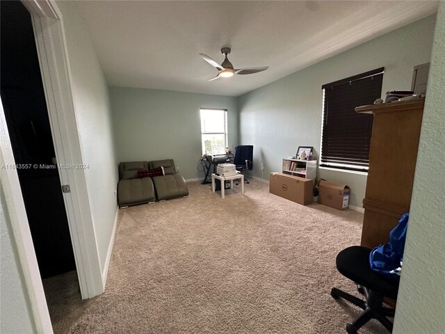 carpeted office with ceiling fan