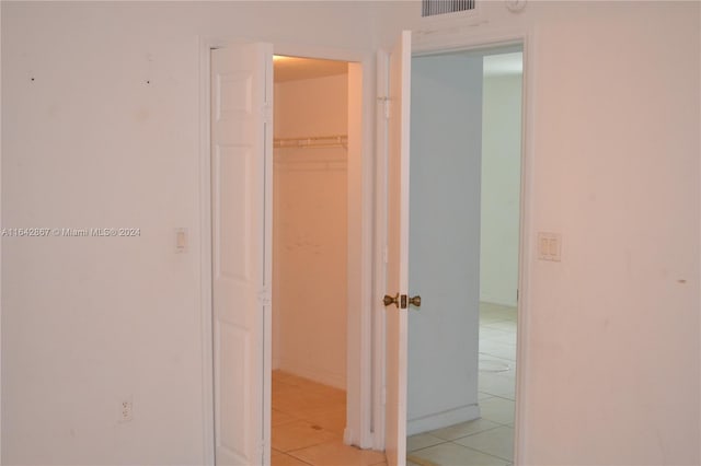 hallway featuring light tile patterned flooring