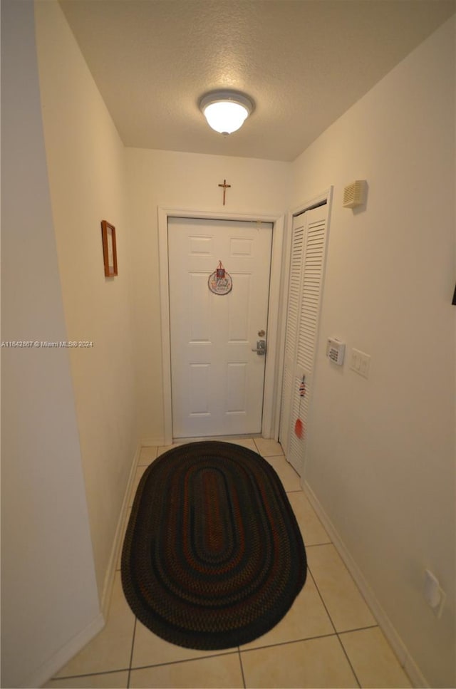 entryway featuring light tile patterned floors