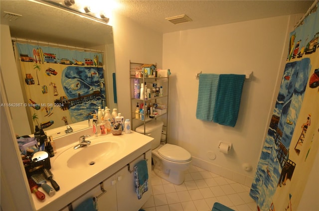 bathroom with a shower with shower curtain, vanity, tile patterned floors, a textured ceiling, and toilet