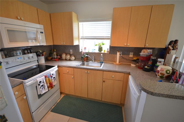 kitchen with sink, decorative backsplash, tile patterned floors, and white appliances