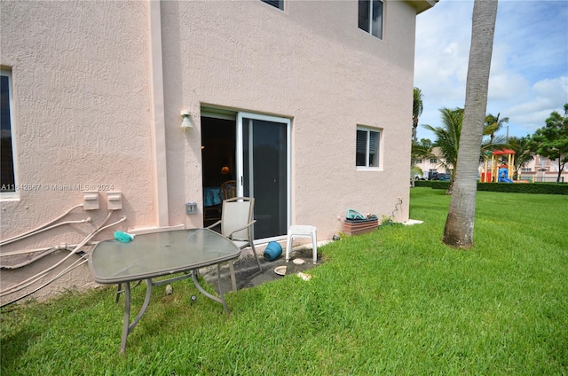 rear view of house with a lawn