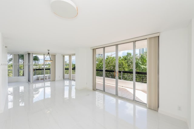 tiled empty room with floor to ceiling windows