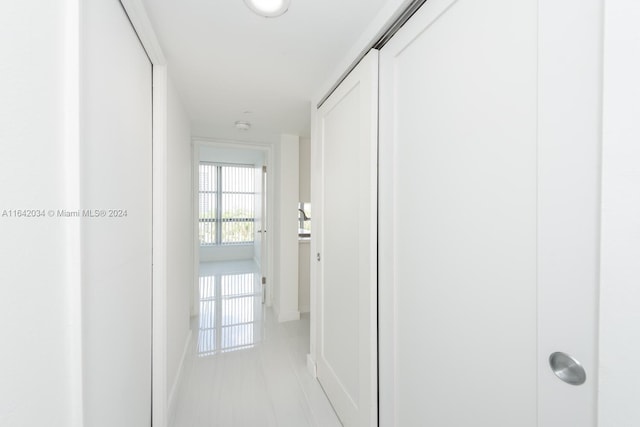 hall featuring light tile patterned floors