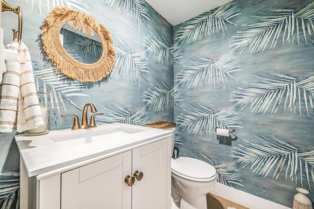 bathroom featuring toilet and vanity