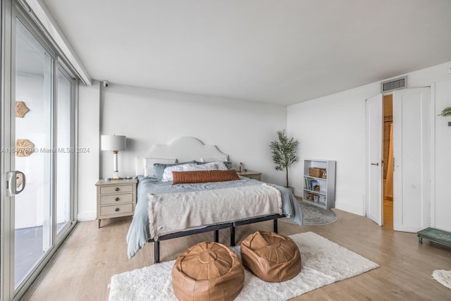 bedroom featuring light hardwood / wood-style floors and access to outside