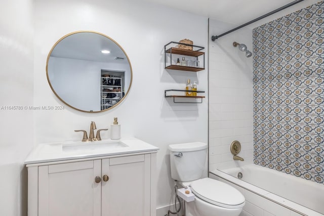 full bathroom featuring toilet, tiled shower / bath combo, and vanity