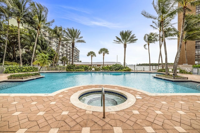 view of swimming pool with a hot tub