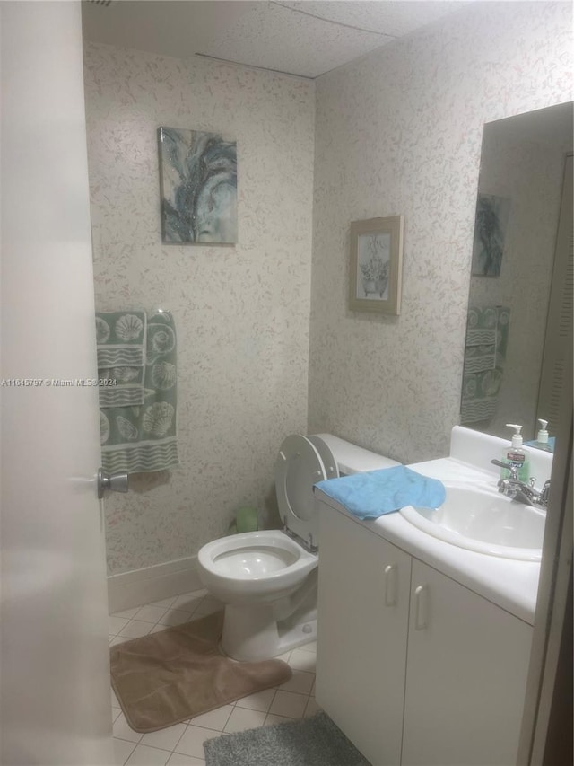 bathroom featuring tile patterned floors, vanity, and toilet