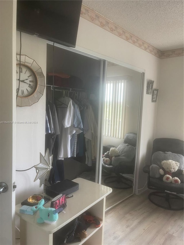 mudroom featuring a textured ceiling and light hardwood / wood-style flooring