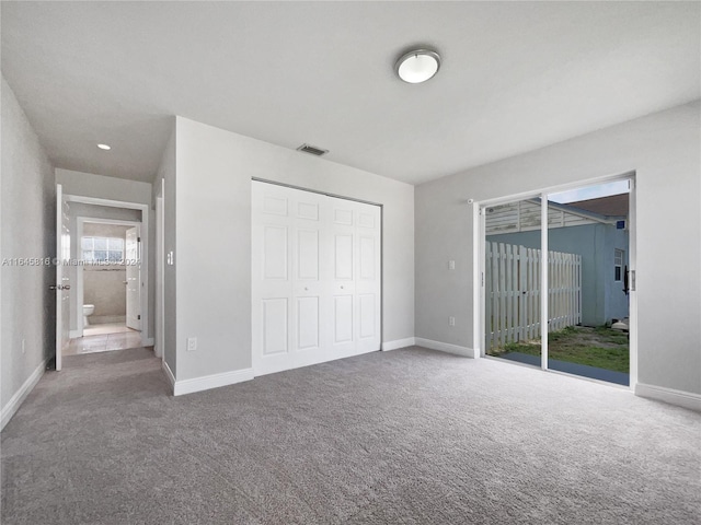 unfurnished bedroom featuring baseboards, carpet floors, and access to exterior