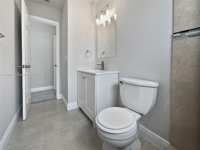 bathroom with tile patterned flooring, vanity, and toilet