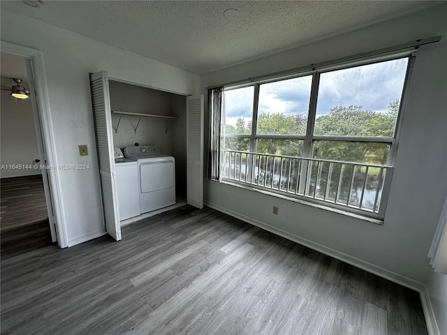 laundry area with a textured ceiling, hardwood / wood-style floors, and washing machine and dryer