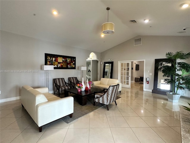 tiled living room with french doors and vaulted ceiling