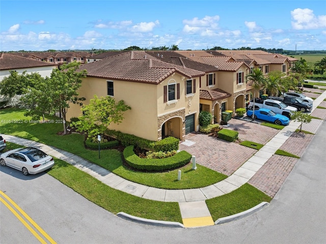 view of front of home with a front lawn and a garage