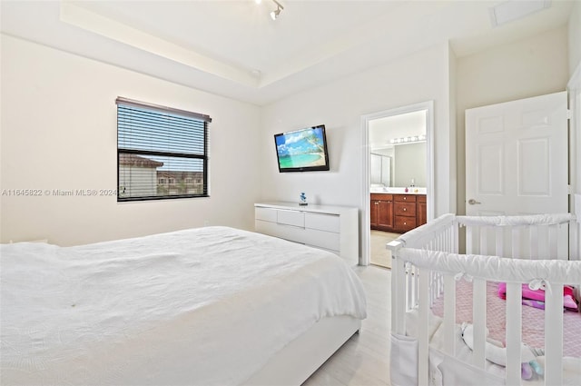 carpeted bedroom featuring ensuite bath