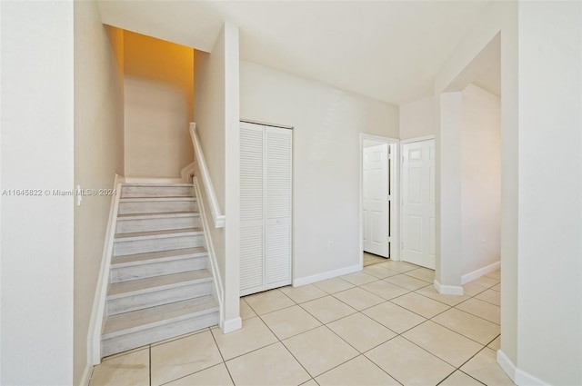 stairway with tile patterned flooring