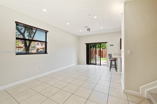 tiled spare room with a wealth of natural light