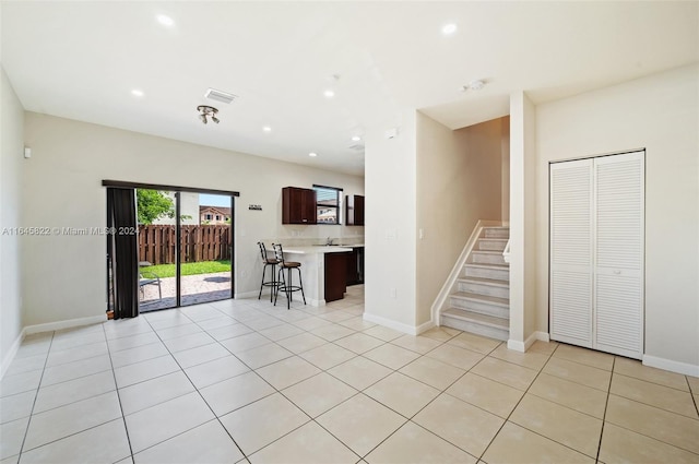 unfurnished living room featuring light tile patterned floors