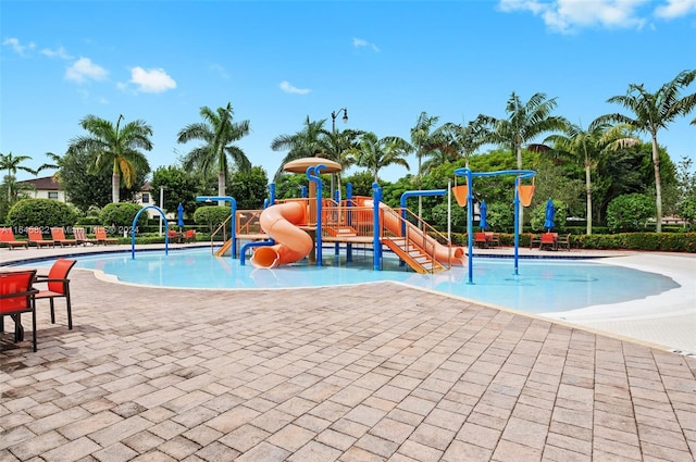 view of jungle gym featuring a patio and a community pool