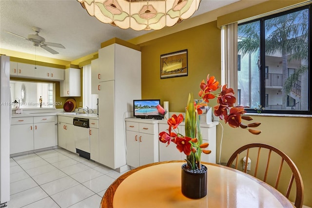 kitchen with white cabinets, dishwasher, ceiling fan, and light tile patterned floors