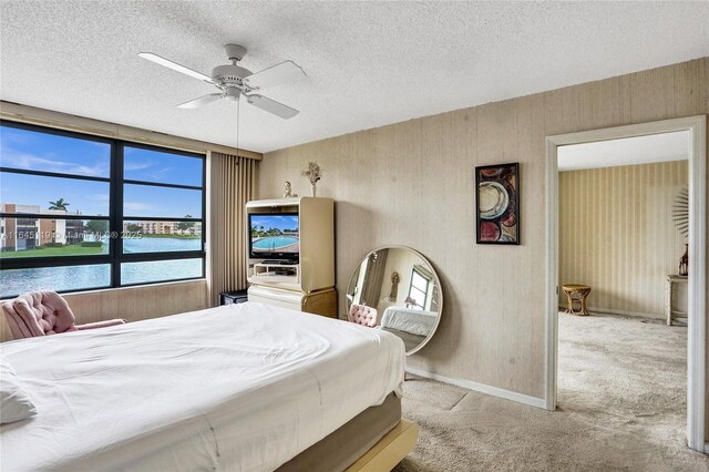 bedroom with light carpet, a textured ceiling, and ceiling fan