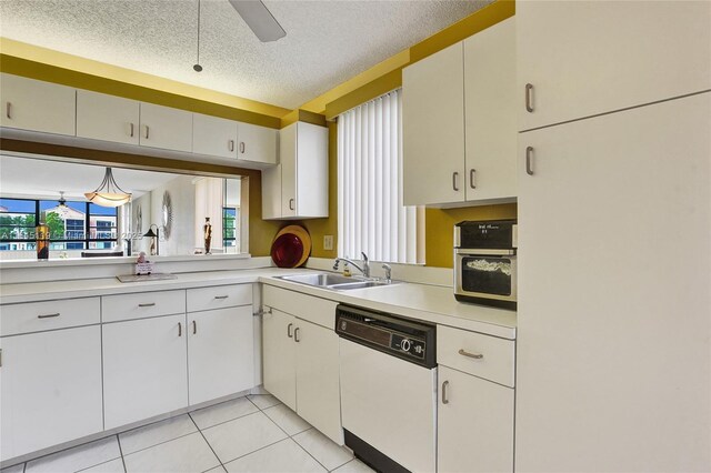 kitchen featuring a textured ceiling, white appliances, ceiling fan, sink, and white cabinets