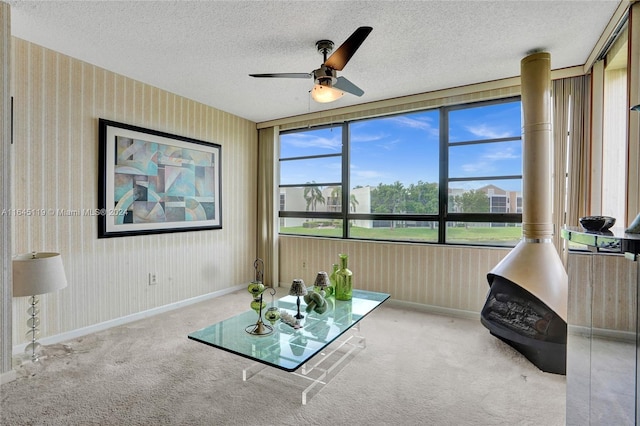 unfurnished room featuring ceiling fan, light colored carpet, and a textured ceiling