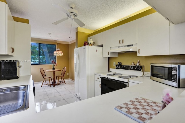 kitchen with white appliances, white cabinetry, hanging light fixtures, and sink