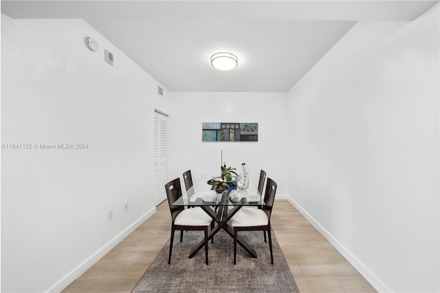 dining space with light hardwood / wood-style floors