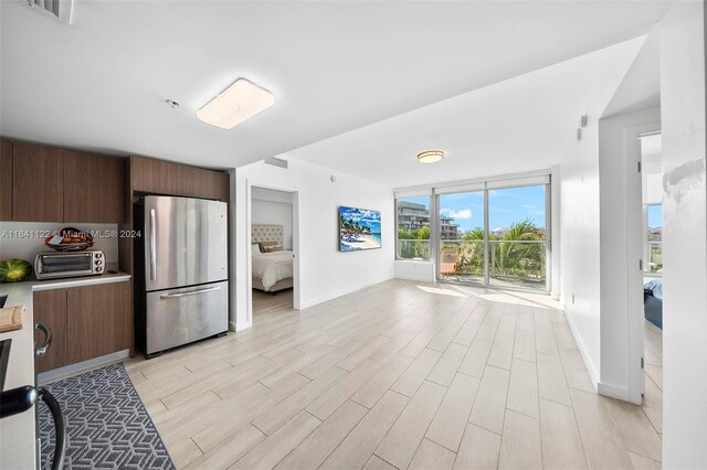 1600 SW 1st Ave Unit 614, Miami, FL 33129 - kitchen featuring a toaster, visible vents, baseboards, freestanding refrigerator, and light wood-style floors