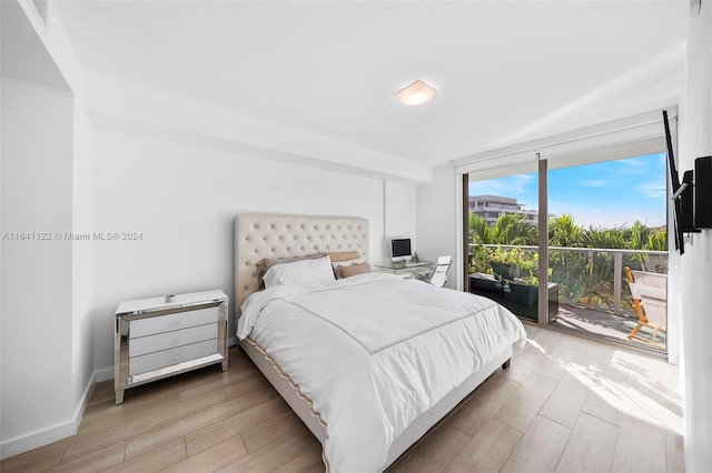 bedroom featuring light hardwood / wood-style flooring and access to outside