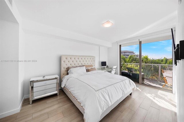 1600 SW 1st Ave Unit 614, Miami, FL 33129 - bedroom featuring baseboards, access to outside, and wood finished floors