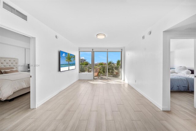 1600 SW 1st Ave Unit 614, Miami, FL 33129 - interior space featuring baseboards, wood finished floors, visible vents, and expansive windows