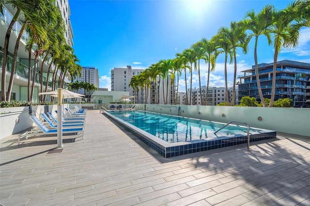 view of swimming pool featuring a hot tub