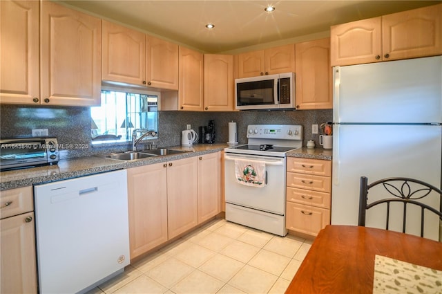 kitchen featuring sink, backsplash, white appliances, light brown cabinetry, and light tile patterned floors