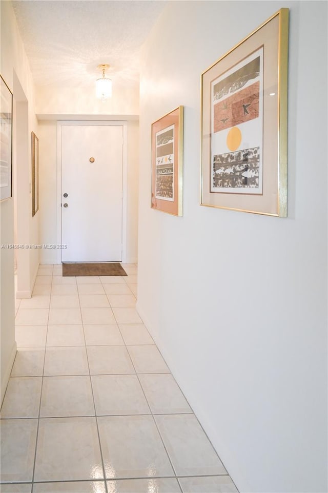 hall with light tile patterned floors