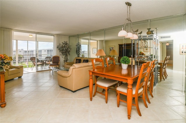 dining room with light tile patterned floors, a textured ceiling, and floor to ceiling windows