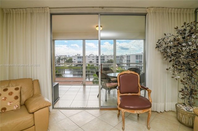 sunroom / solarium featuring a water view and plenty of natural light