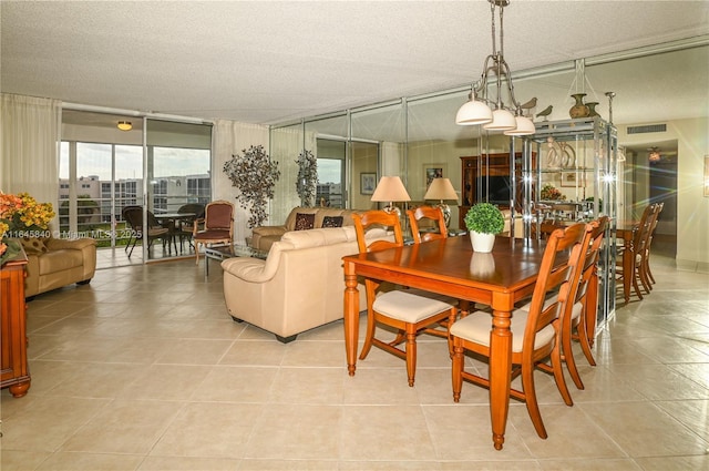 dining space with floor to ceiling windows and light tile patterned floors