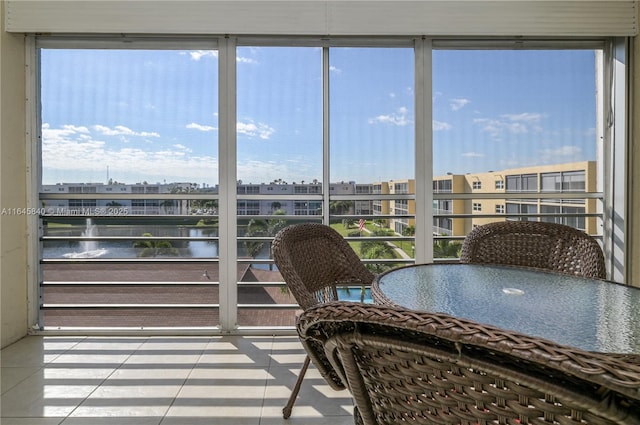 sunroom / solarium featuring a water view