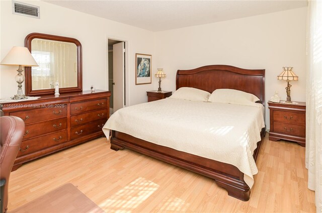 bedroom with light hardwood / wood-style floors