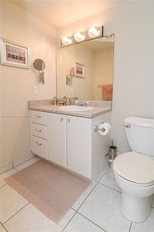 bathroom with tile patterned floors, vanity, and toilet