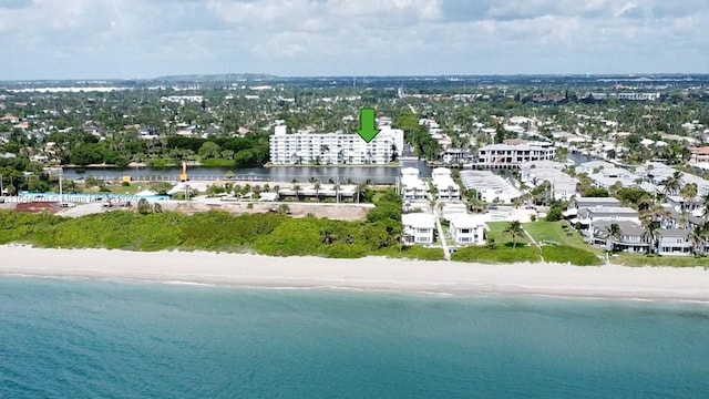 drone / aerial view featuring a water view and a view of the beach