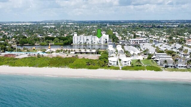 bird's eye view featuring a water view and a beach view