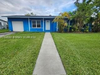 view of front facade with a front yard and a garage