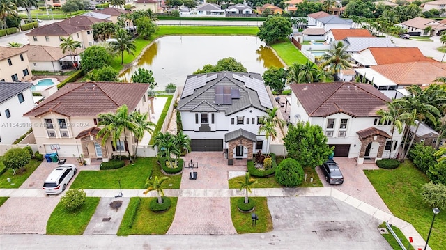 bird's eye view with a water view and a residential view