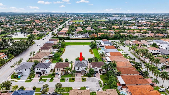 bird's eye view featuring a residential view and a water view