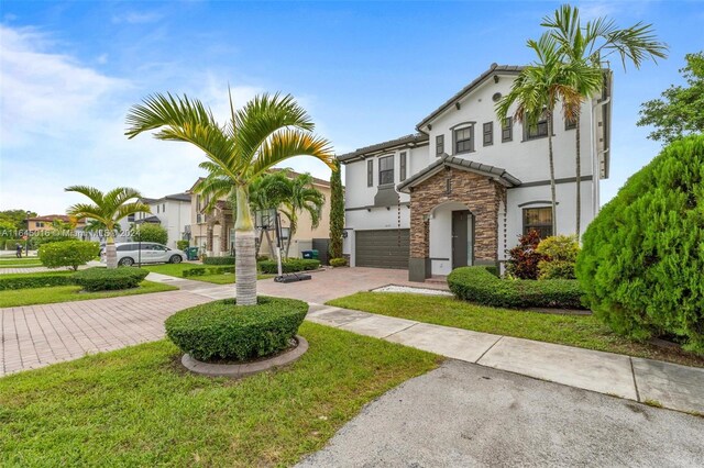 view of front of home with a garage and a front yard